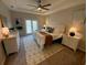 Well-decorated main bedroom featuring a tray ceiling, ceiling fan, neutral colors, and a plush rug at 5709 Wild Sage Cir, Sarasota, FL 34238