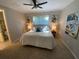 Comfortable main bedroom featuring a king bed, bedside lamps, and stylish artwork at 5709 Wild Sage Cir, Sarasota, FL 34238