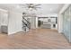 Open floor plan featuring hardwood floors connecting the living area, kitchen, and staircase at 5709 Wild Sage Cir, Sarasota, FL 34238
