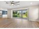 A bright sunroom leads to a backyard with a view of lush grass and a pond at 5709 Wild Sage Cir, Sarasota, FL 34238