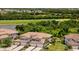 Gorgeous home with landscaping, a tile roof, and paver driveway, set against golf course and pond views at 5843 Wake Forest Run # 104, Bradenton, FL 34211