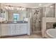 Bright bathroom featuring double vanity, shower, and soaking tub at 5843 Wake Forest Run # 104, Bradenton, FL 34211