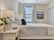 Comfortable bedroom with a boat painting, a ceiling fan, a window, and white furniture at 5843 Wake Forest Run # 104, Bradenton, FL 34211