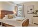 Bedroom featuring a tropical painting, woven bed frame, and a ceiling fan, radiating relaxation and style at 5843 Wake Forest Run # 104, Bradenton, FL 34211