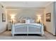 Bright bedroom with a white bed frame, side tables, neutral décor, and soft lighting at 5843 Wake Forest Run # 104, Bradenton, FL 34211