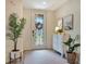 Welcoming foyer with a decorative glass door, a patterned area rug, a console table, and stylish décor at 5843 Wake Forest Run # 104, Bradenton, FL 34211