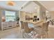 Cozy kitchen area featuring a breakfast bar, natural light, and a stylish design at 5843 Wake Forest Run # 104, Bradenton, FL 34211