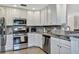 Well-equipped kitchen with stainless steel appliances, granite countertops, and ample cabinet space at 5843 Wake Forest Run # 104, Bradenton, FL 34211
