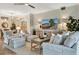 Elegant living room with a ceiling fan, comfortable seating, decorative lamps, and a stylish media console at 5843 Wake Forest Run # 104, Bradenton, FL 34211