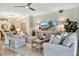 Spacious living room featuring a large TV, comfortable seating, and contemporary design at 5843 Wake Forest Run # 104, Bradenton, FL 34211