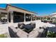 Inviting outdoor lounge with comfortable seating, a fire pit, and a covered bar area, perfect for socializing and relaxation at 5843 Wake Forest Run # 104, Bradenton, FL 34211
