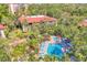 An aerial view shows the community pool and mature trees on the property at 6501 Mourning Dove Dr # 215, Bradenton, FL 34210