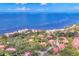 Overhead view showcases waterfront condos amidst trees with water views, capturing the community's serene coastal charm at 6501 Mourning Dove Dr # 215, Bradenton, FL 34210