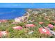 Scenic aerial view of waterfront condos with lush landscaping and red tile roofs against a blue sky and water backdrop at 6501 Mourning Dove Dr # 215, Bradenton, FL 34210