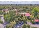 Aerial view showing condo buildings nestled among the trees, a carport, and ample parking spaces at 6501 Mourning Dove Dr # 215, Bradenton, FL 34210