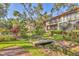 Scenic backyard featuring a charming wooden bridge over a small stream with lush landscaping at 6501 Mourning Dove Dr # 215, Bradenton, FL 34210