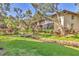 Lush backyard featuring a small wooden bridge over a small stream and mature trees at 6501 Mourning Dove Dr # 215, Bradenton, FL 34210