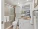 Well-lit bathroom features a glass-enclosed shower, white vanity, and neutral decor at 6501 Mourning Dove Dr # 215, Bradenton, FL 34210