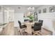 Elegant dining room with stylish chandelier, wainscoting, and natural wood-look flooring at 6501 Mourning Dove Dr # 215, Bradenton, FL 34210