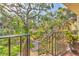 Landscaped exterior staircase and mature tropical foliage create an inviting entrance to the property at 6501 Mourning Dove Dr # 215, Bradenton, FL 34210