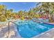 A refreshing community pool is surrounded by comfortable lounge seating and lush tropical landscaping at 6501 Mourning Dove Dr # 215, Bradenton, FL 34210
