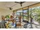 Enclosed porch with an outdoor dining set and open views of the backyard landscaping at 6501 Mourning Dove Dr # 215, Bradenton, FL 34210