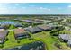 Expansive aerial view showcasing a vibrant community with lush landscaping and serene water features at 7136 Summerland Cv, Bradenton, FL 34202