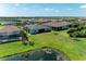 Backyard aerial view of a private backyard with a pool and serene pond view at 7136 Summerland Cv, Bradenton, FL 34202