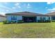 Backyard view of the home featuring a patio and lush green lawn at 7136 Summerland Cv, Bradenton, FL 34202