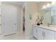 Bathroom featuring a double sink vanity, a separate toilet room, and a shower at 7136 Summerland Cv, Bradenton, FL 34202