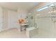 Modern bathroom with a glass-enclosed shower and a vanity area with a stool at 7136 Summerland Cv, Bradenton, FL 34202