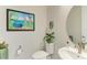 Compact powder room features fun artwork, a vanity sink, and decorative accents at 7136 Summerland Cv, Bradenton, FL 34202