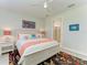 Bright bedroom featuring art, ceiling fan, and ensuite bath access at 7136 Summerland Cv, Bradenton, FL 34202