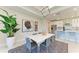 Modern dining area with stylish furniture, contemporary art, and an open view to the kitchen at 7136 Summerland Cv, Bradenton, FL 34202