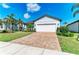Charming home with brick driveway and manicured lawn, showcasing curb appeal and an inviting facade at 7136 Summerland Cv, Bradenton, FL 34202
