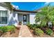 Inviting front entrance with brick pathway leading to a glass-paneled door and well-maintained landscaping at 7136 Summerland Cv, Bradenton, FL 34202