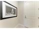 Hallway with an interior door and an artistic framed portrait on the wall at 7136 Summerland Cv, Bradenton, FL 34202