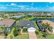 Aerial view of a charming one-story home with brick driveway and manicured landscaping at 7136 Summerland Cv, Bradenton, FL 34202
