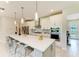 Gourmet kitchen with a spacious island, pendant lighting, and modern amenities for culinary enthusiasts at 7136 Summerland Cv, Bradenton, FL 34202