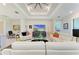 Inviting living room featuring white sofas, modern decor, and an adjacent office space at 7136 Summerland Cv, Bradenton, FL 34202