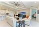 Open-concept living space with tile floors, stylish furnishings, and seamless flow to the kitchen at 7136 Summerland Cv, Bradenton, FL 34202