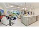 Open-concept living area featuring a large island, modern lighting, and a view of the backyard at 7136 Summerland Cv, Bradenton, FL 34202