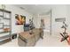 Spacious home office with a dark wooden desk, chair, and large decorative artwork at 7136 Summerland Cv, Bradenton, FL 34202