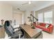 Bright office with a sleek desk, stylish lighting, and a comfortable red sofa at 7136 Summerland Cv, Bradenton, FL 34202