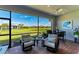 Enclosed patio with outdoor seating and scenic views of the green space and a pond at 7136 Summerland Cv, Bradenton, FL 34202