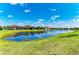 Scenic pond surrounded by lush greenery and well-maintained homes in a vibrant community at 7136 Summerland Cv, Bradenton, FL 34202