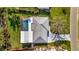 Overhead shot of a home with a screen-enclosed pool, showcasing the roof, landscaping, and driveway at 7817 Alhambra Dr, Bradenton, FL 34209