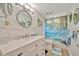 Bright bathroom with a palm tree themed shower curtain and modern fixtures at 7817 Alhambra Dr, Bradenton, FL 34209