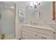 Well-lit bathroom featuring beadboard walls, a glass enclosed shower, and modern fixtures at 7817 Alhambra Dr, Bradenton, FL 34209