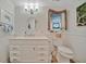 Charming bathroom featuring beadboard walls, vanity with drawers, and decorative window treatments at 7817 Alhambra Dr, Bradenton, FL 34209